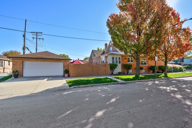 view of front of house featuring a front yard, an outdoor structure, and a garage