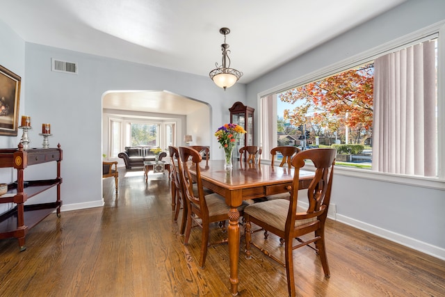 dining space with dark hardwood / wood-style flooring