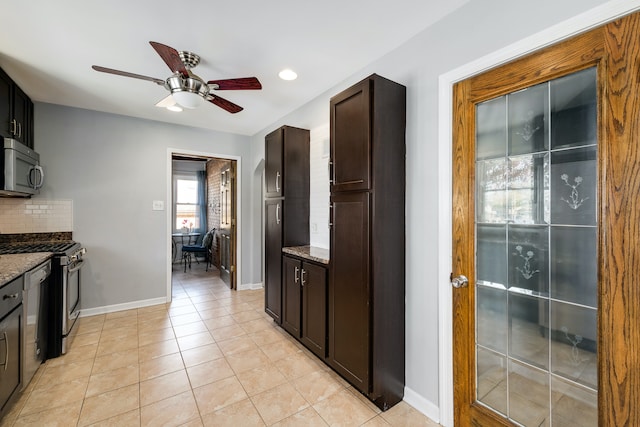 kitchen featuring ceiling fan, light stone countertops, backsplash, and appliances with stainless steel finishes