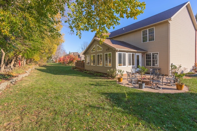 back of house with a lawn and a patio