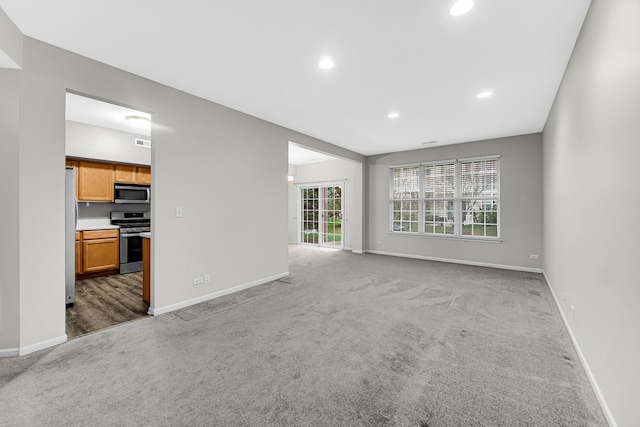 unfurnished living room featuring carpet floors