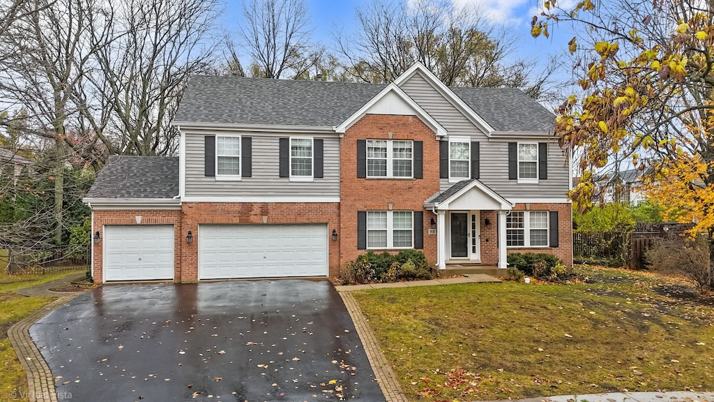 view of front of property featuring a front lawn and a garage