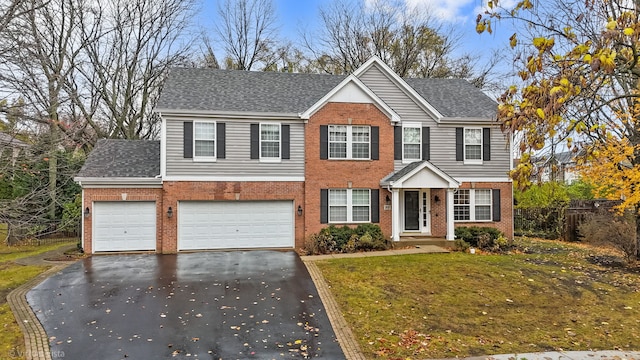 view of front of property featuring a front lawn and a garage