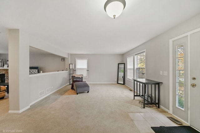 living area featuring a fireplace and light carpet