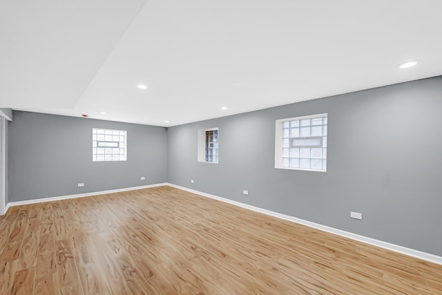 basement with baseboards, recessed lighting, and light wood-style floors