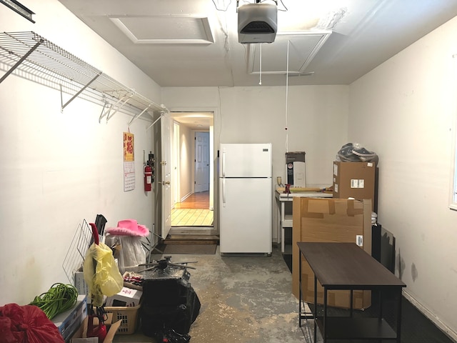 interior space featuring white refrigerator and a garage door opener