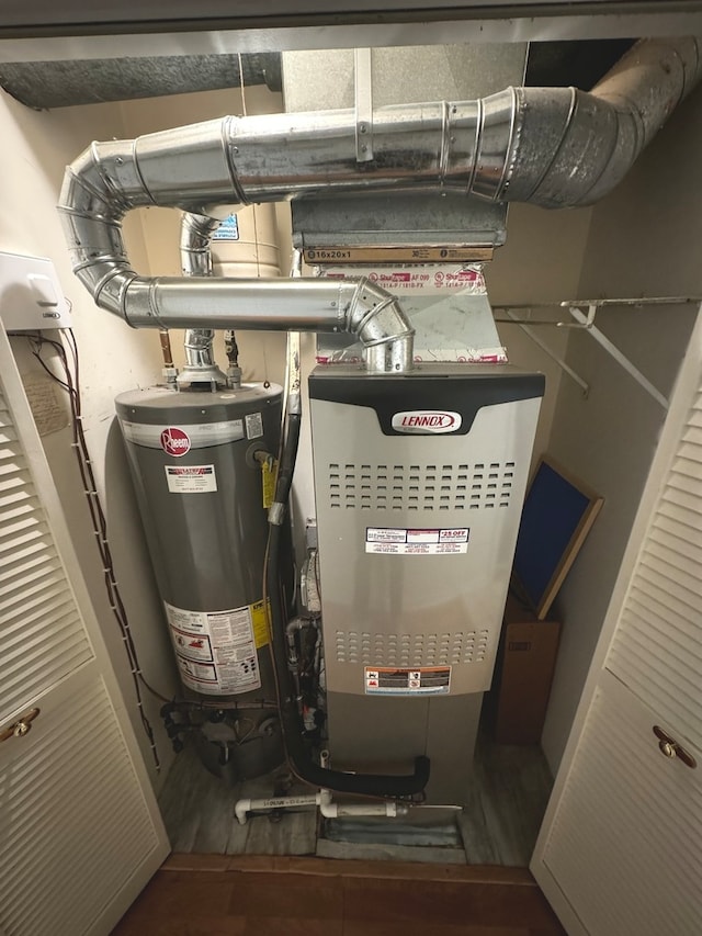 utility room featuring water heater