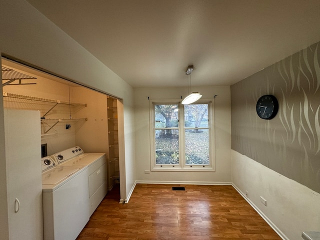 washroom featuring hardwood / wood-style floors and washer and dryer