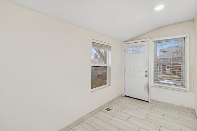 foyer entrance featuring vaulted ceiling