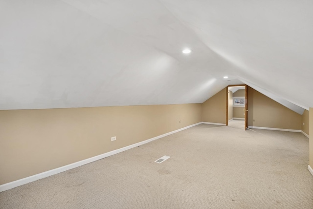 bonus room featuring light colored carpet and lofted ceiling