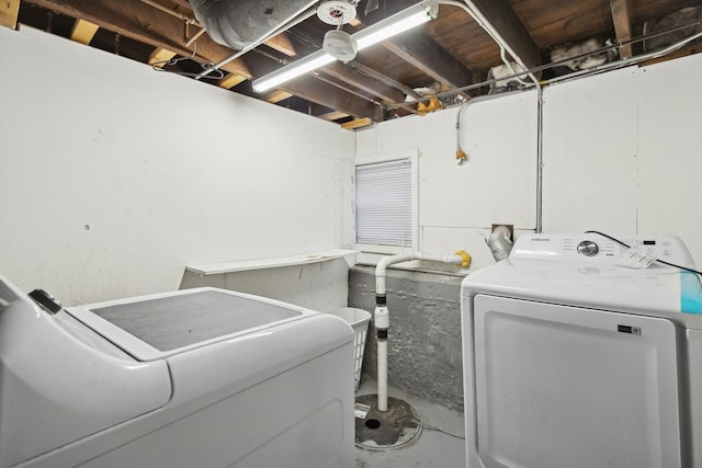 clothes washing area featuring separate washer and dryer