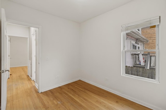 spare room with wood-type flooring