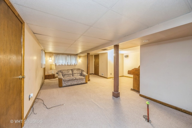 basement with a paneled ceiling