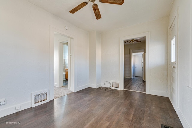 unfurnished room with dark wood-type flooring