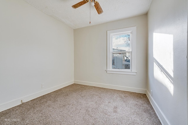 carpeted spare room featuring ceiling fan and a textured ceiling