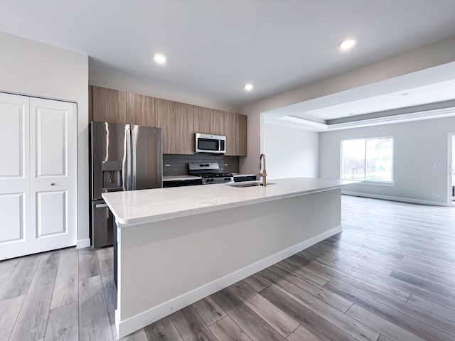 235 Regency Ct Unit B, Wauconda, IL 60084 - kitchen with stainless steel appliances, a sink, modern cabinets, brown cabinetry, and recessed lighting