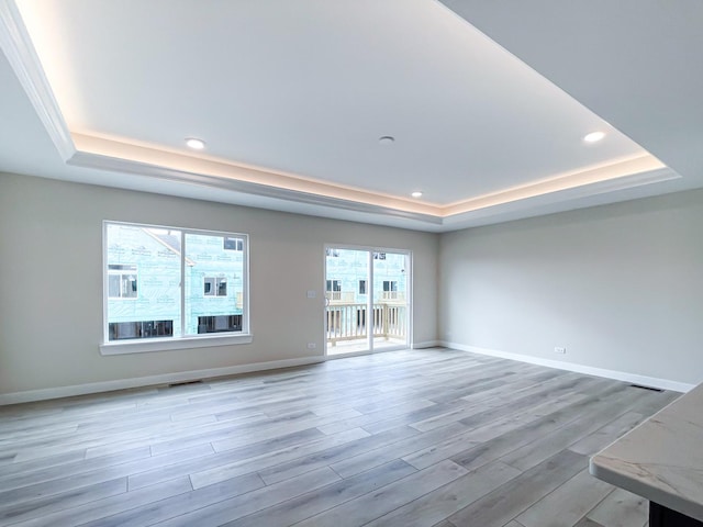 235 Regency Ct Unit B, Wauconda, IL 60084 - empty room with a tray ceiling, light wood-style floors, baseboards, and recessed lighting