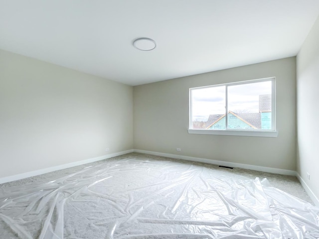 235 Regency Ct Unit B, Wauconda, IL 60084 - spare room featuring baseboards and light carpet
