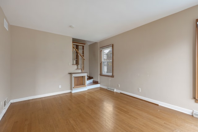 unfurnished living room with light hardwood / wood-style floors