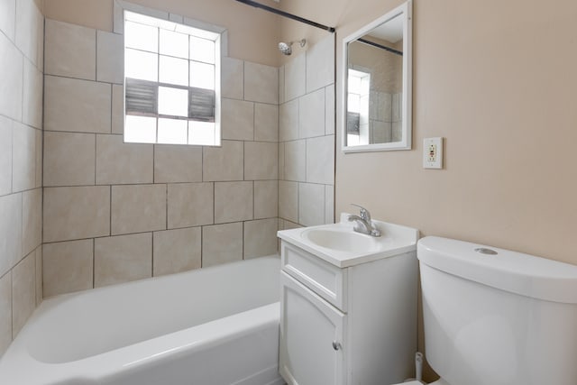 full bathroom featuring vanity, toilet, and tiled shower / bath