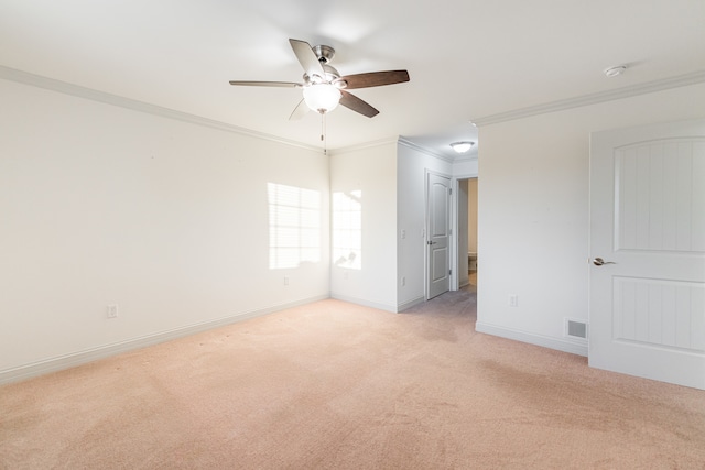 unfurnished room with ornamental molding, light colored carpet, and ceiling fan