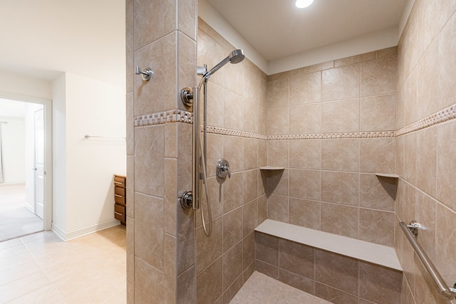 bathroom with tile patterned flooring and tiled shower