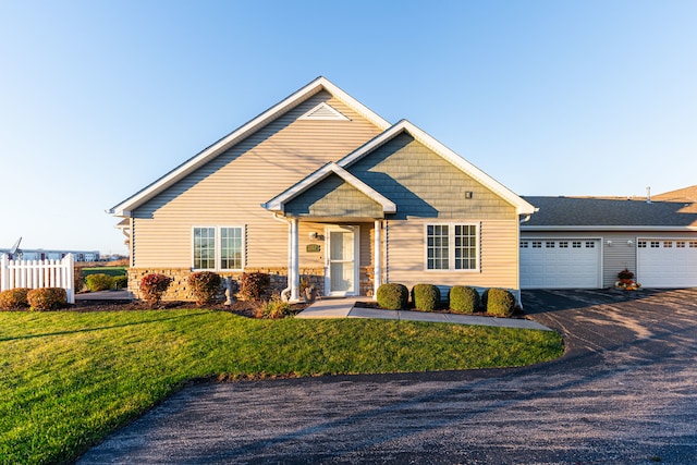 view of front of house with a garage and a front yard