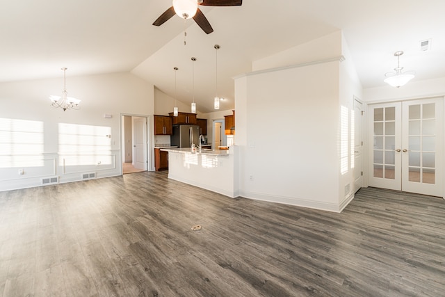 unfurnished living room featuring dark wood-type flooring, a wealth of natural light, and french doors