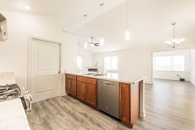 kitchen with pendant lighting, light wood-type flooring, appliances with stainless steel finishes, and vaulted ceiling