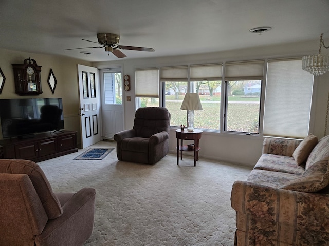 carpeted living room with ceiling fan