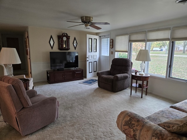 carpeted living room featuring ceiling fan