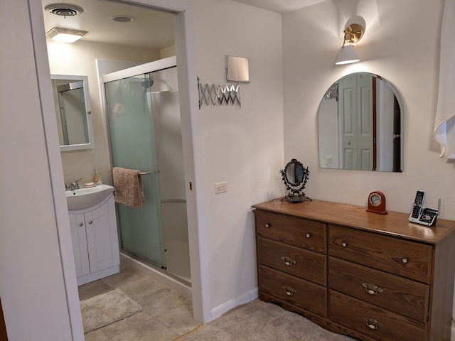 bathroom featuring vanity and a shower with door