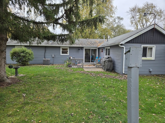 back of house featuring a patio area, central air condition unit, and a lawn