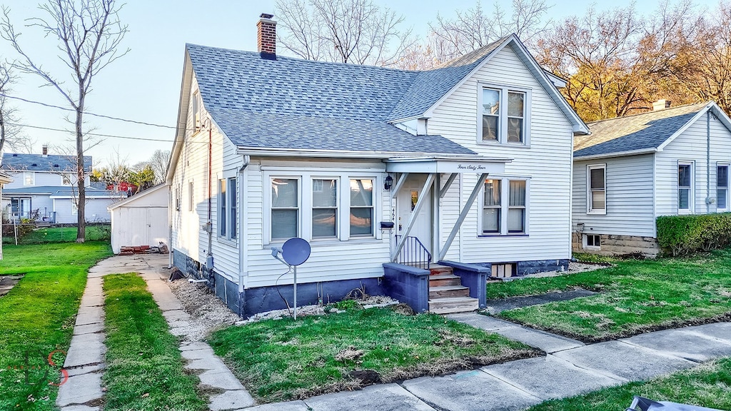 bungalow-style home featuring a front yard