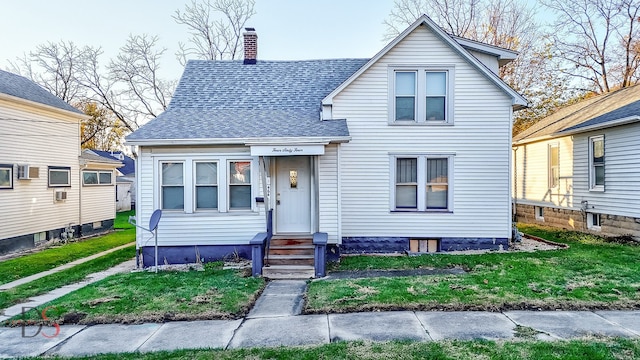 bungalow-style house featuring a front yard