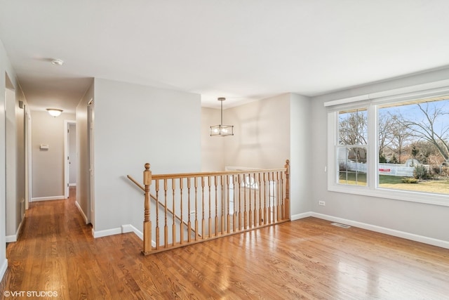 interior space with hardwood / wood-style flooring and an inviting chandelier