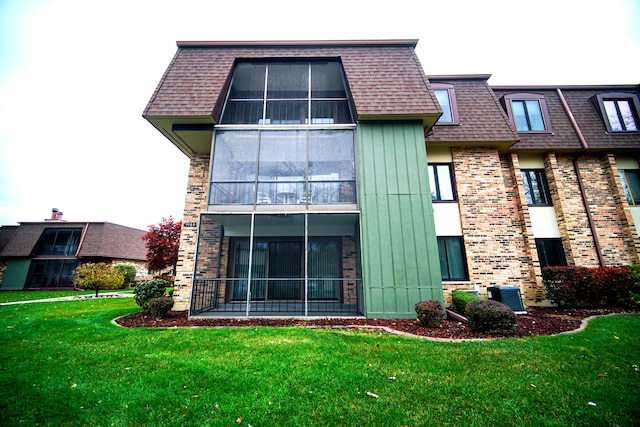 back of house featuring central AC and a yard