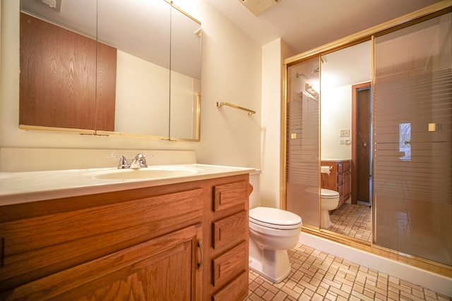 bathroom featuring tile patterned flooring, vanity, toilet, and a shower with door