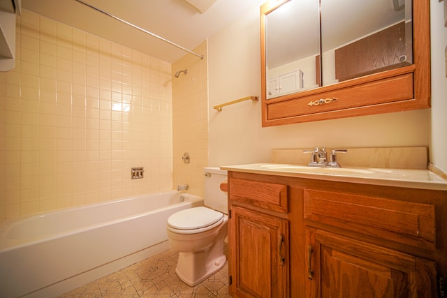 full bathroom featuring tile patterned flooring, vanity, toilet, and tiled shower / bath combo