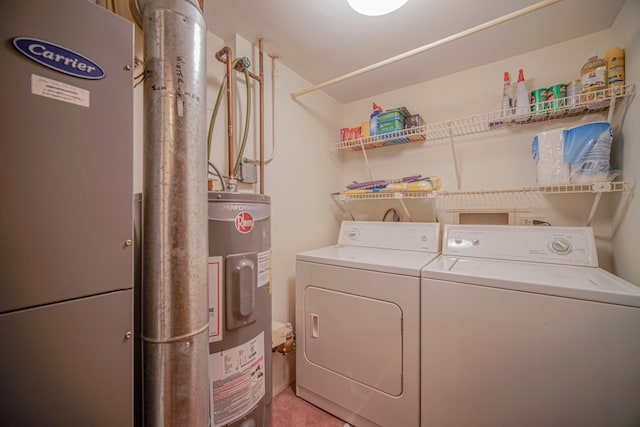 laundry room featuring washing machine and dryer and water heater