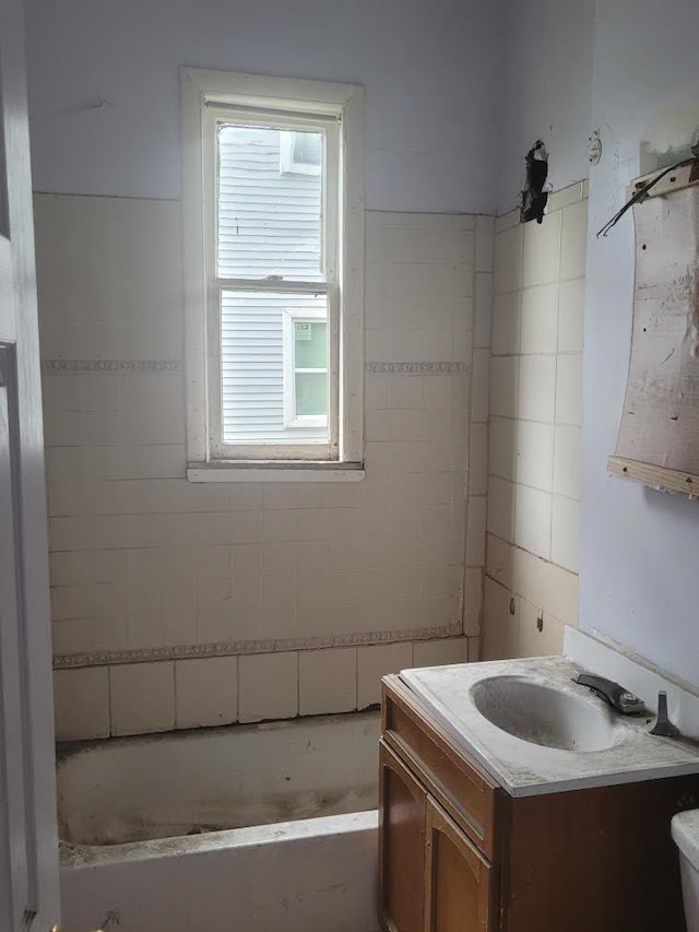 bathroom featuring vanity, plenty of natural light, and toilet