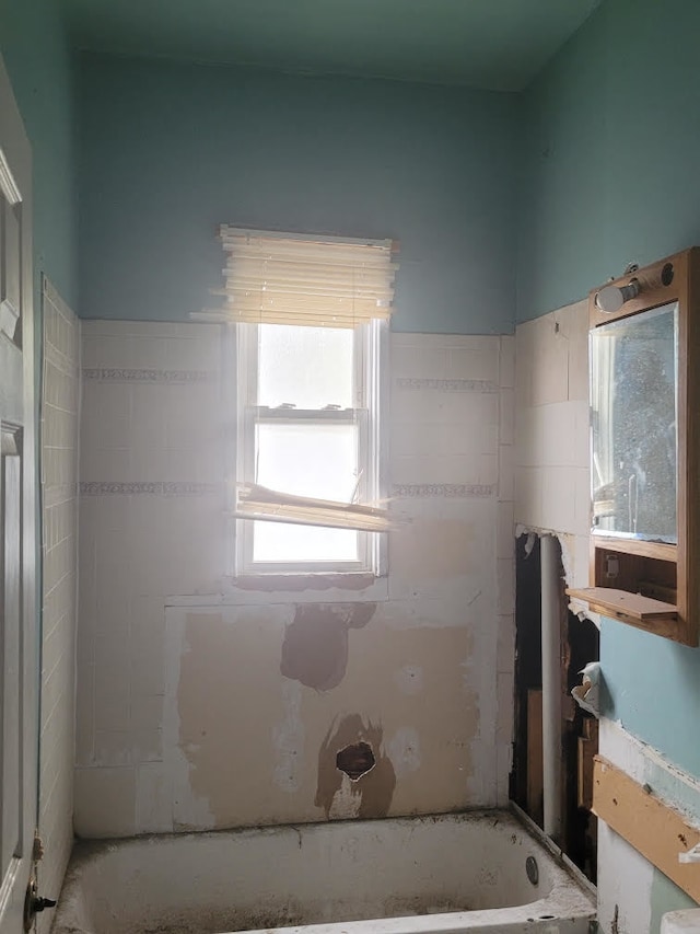 bathroom featuring a tub to relax in