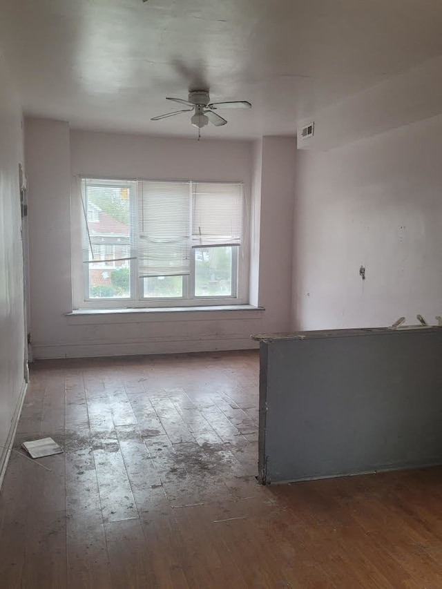 empty room featuring hardwood / wood-style flooring and ceiling fan