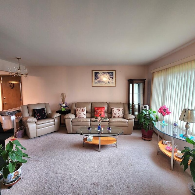 carpeted living room featuring an inviting chandelier