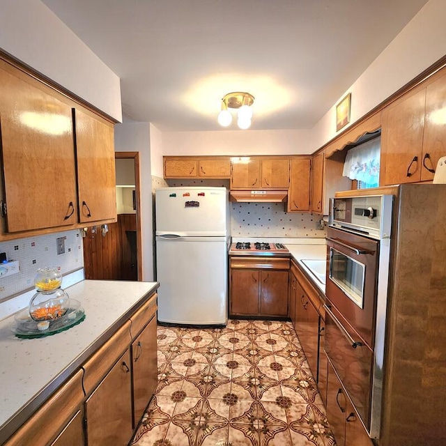 kitchen with stainless steel appliances and tasteful backsplash