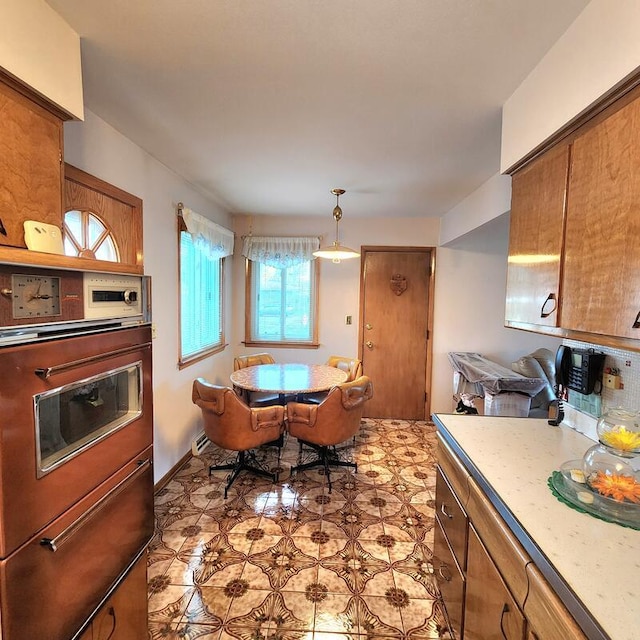 kitchen featuring stainless steel oven and decorative light fixtures