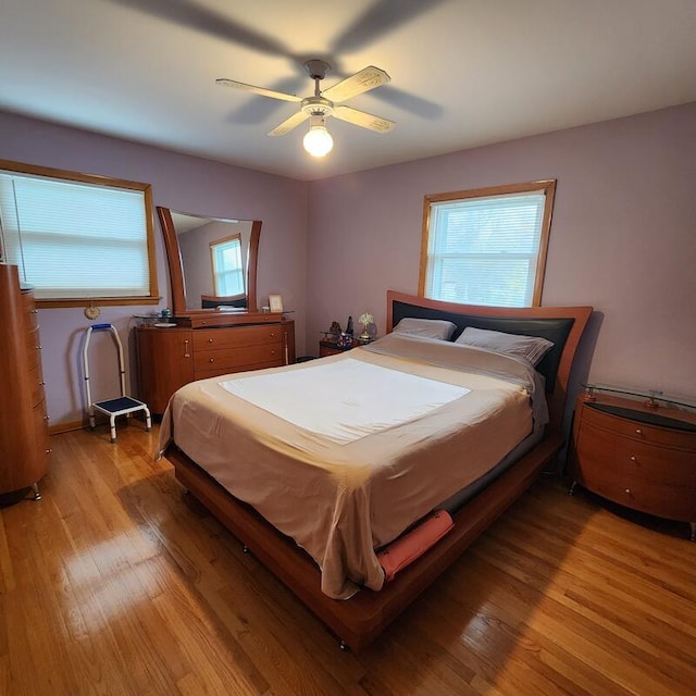 bedroom with light hardwood / wood-style flooring and ceiling fan