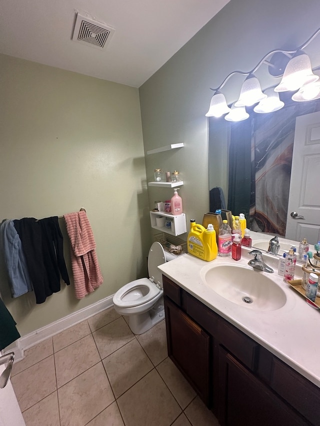 bathroom featuring toilet, vanity, and tile patterned floors