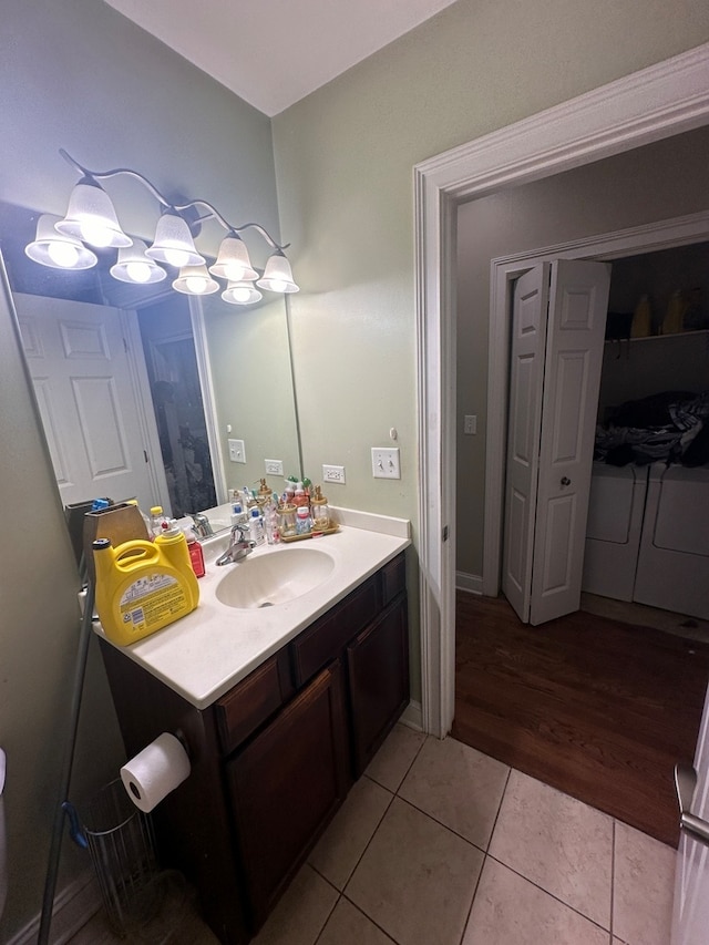 bathroom featuring vanity, wood-type flooring, and washer and dryer