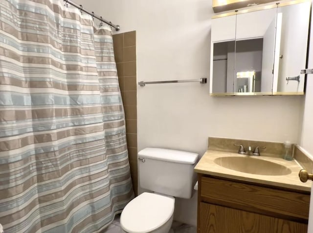 bathroom with toilet, curtained shower, and vanity